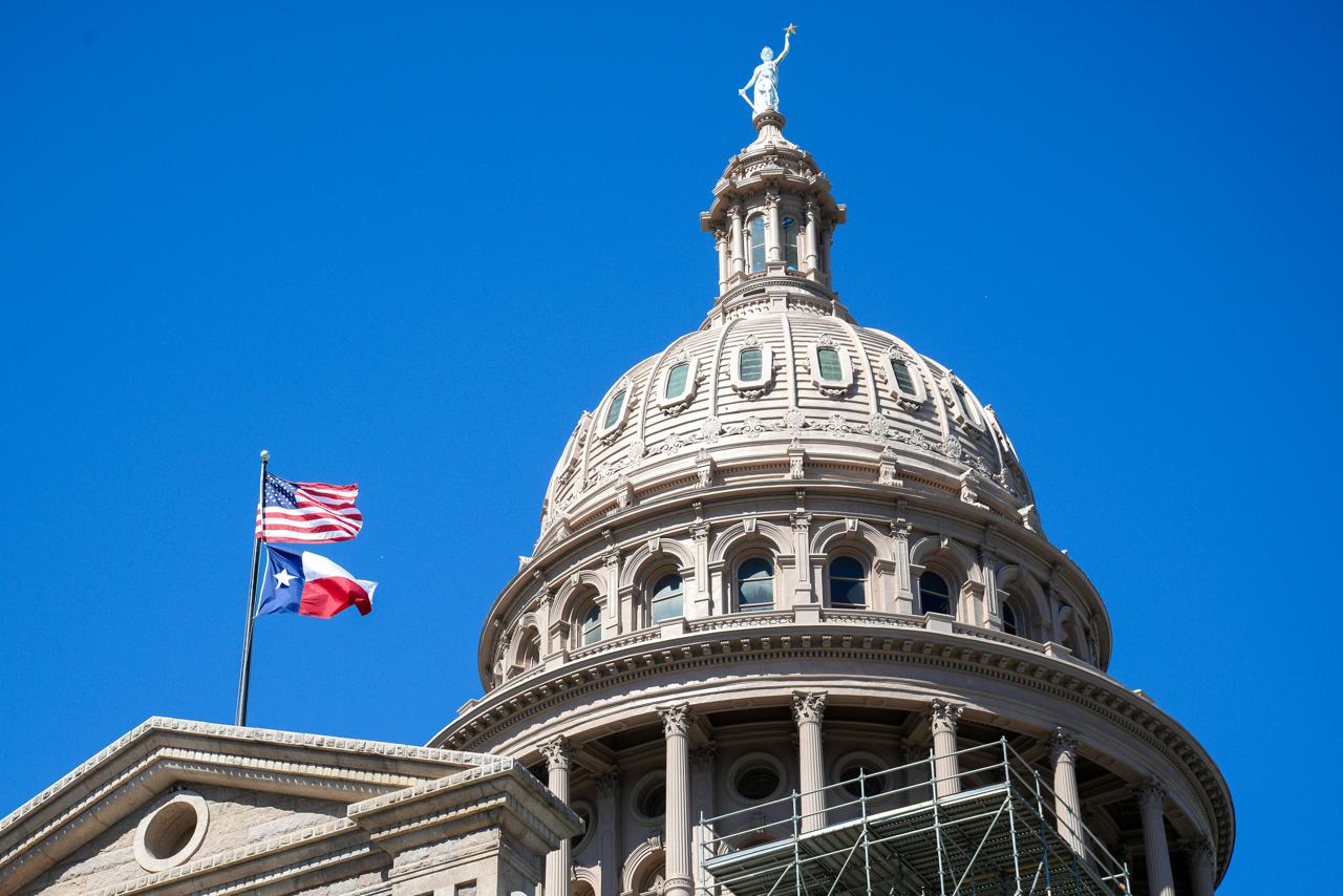 Texas Capitol dome and flags in Austin